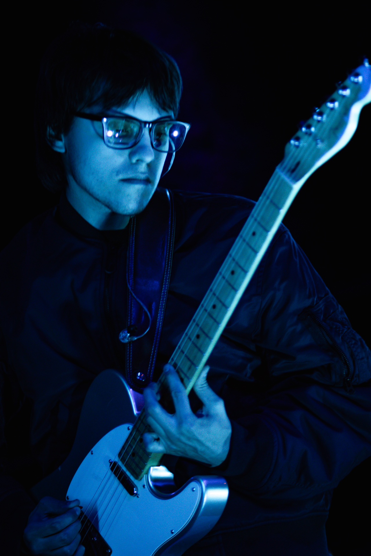 Guitarist in deep blue light