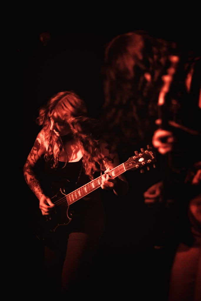 Guitarist bathed in red light